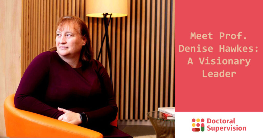 Professor Denise Hawkes seated in a modern office space, promoting inclusive leadership in economics and higher education.